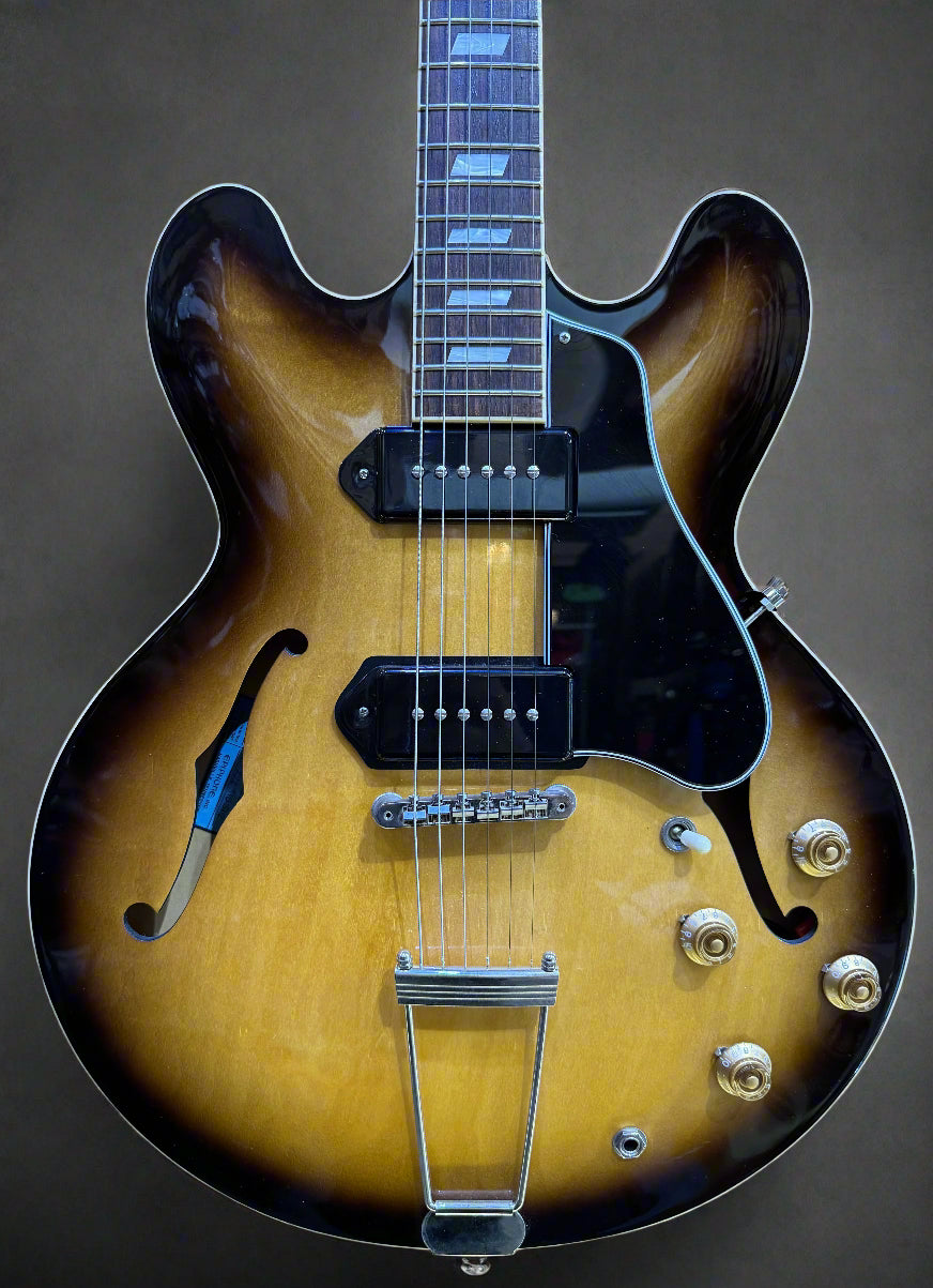 Electric guitar with a sunburst finish on a dark background