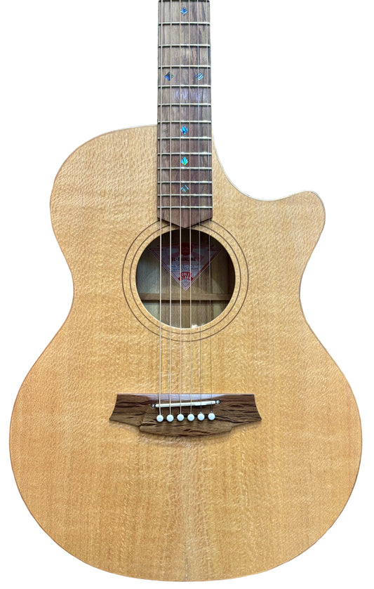 Cole Clark acoustic-electric guitar with a natural satin finish, silky oak wood, and abalone snowflake inlays, displayed in a store among other guitars.