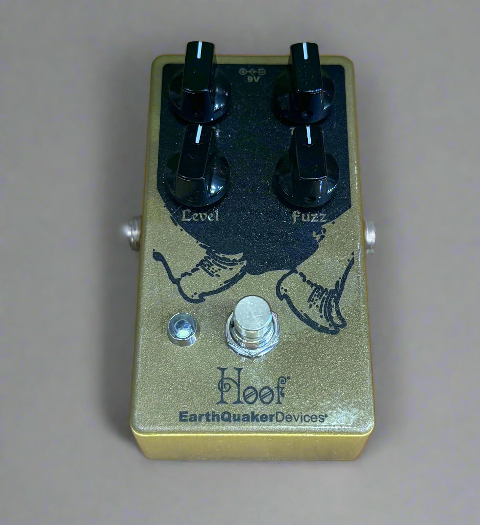 Guitar effects pedal with 'Hoof' and 'EarthQuaker Devices' branding on a wooden surface.