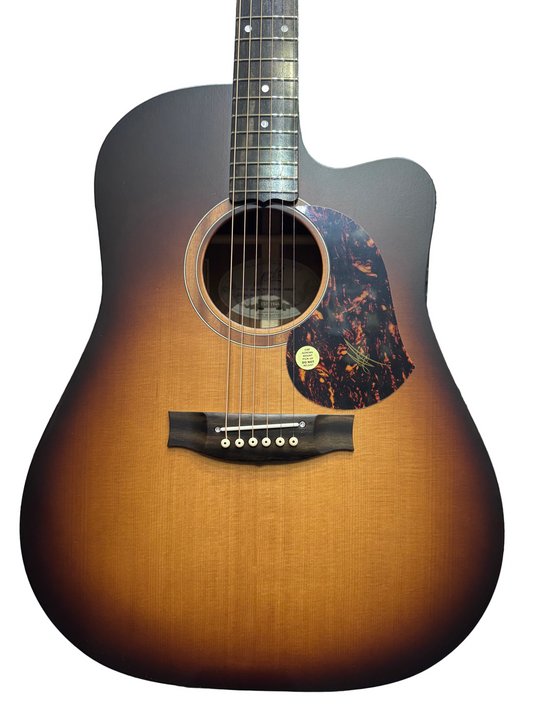 Acoustic guitar with a sunburst finish in a music store setting