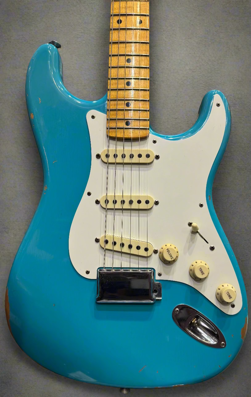 Blue electric guitar with a white pickguard in a store setting