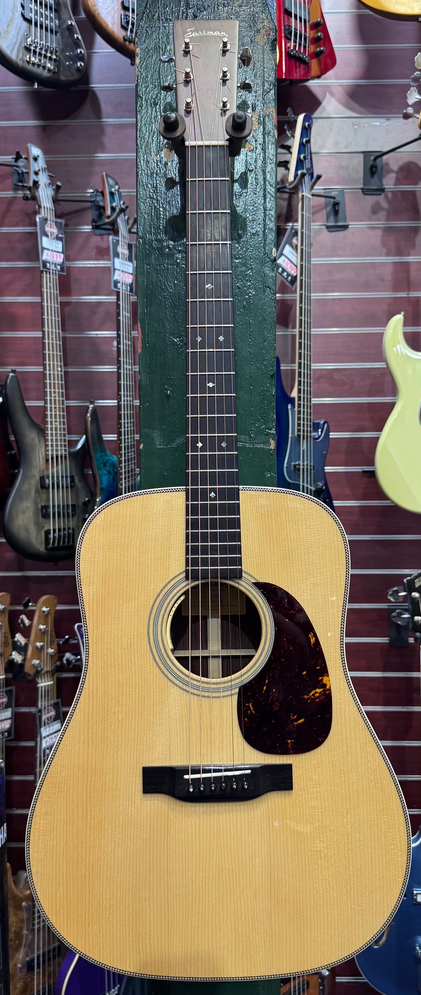 Acoustic guitar with a blurred background of other guitars