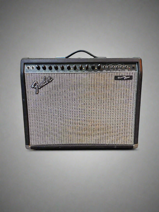 Fender guitar amplifier on a gray floor with Marshall amplifiers in the background