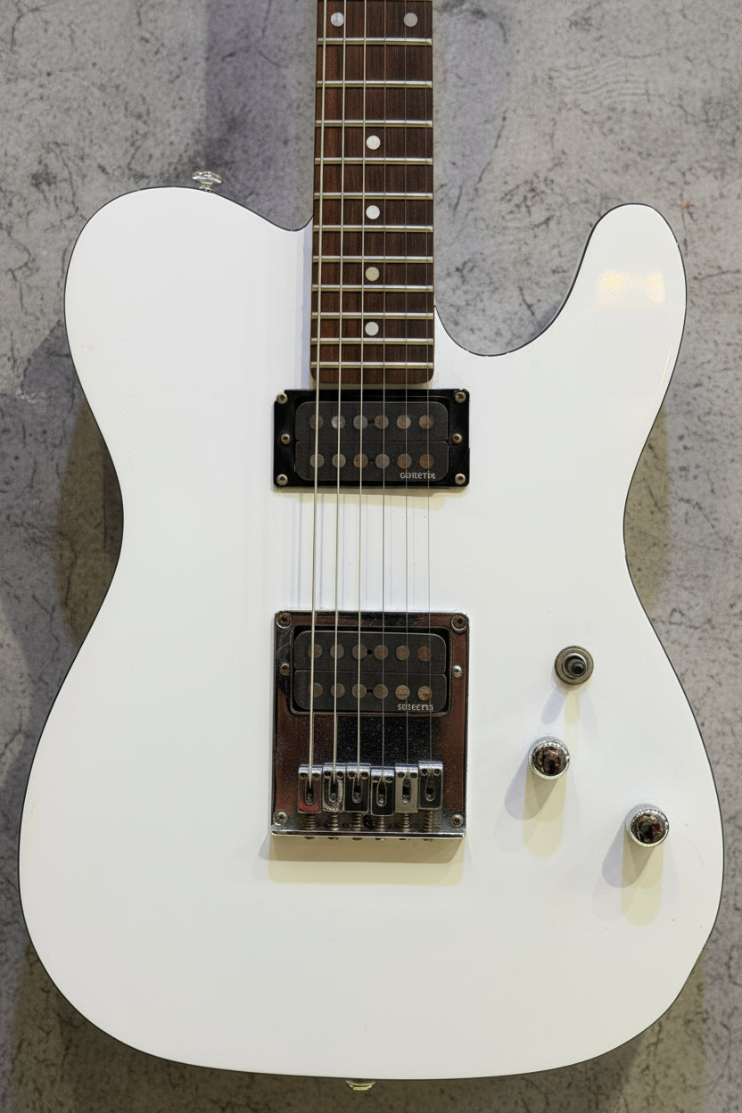 White electric guitar on a wooden background