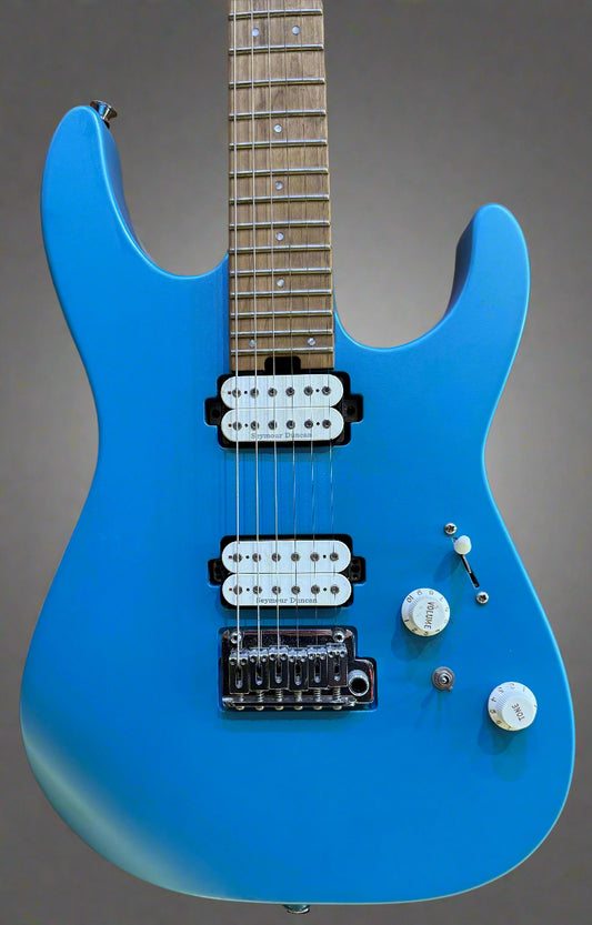 Blue electric guitar on a wooden background
