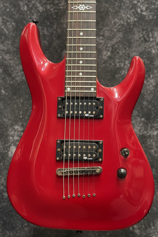 Red electric guitar with a green case in the background