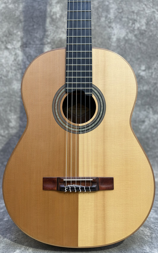 Acoustic guitar with a wooden finish on a wooden background