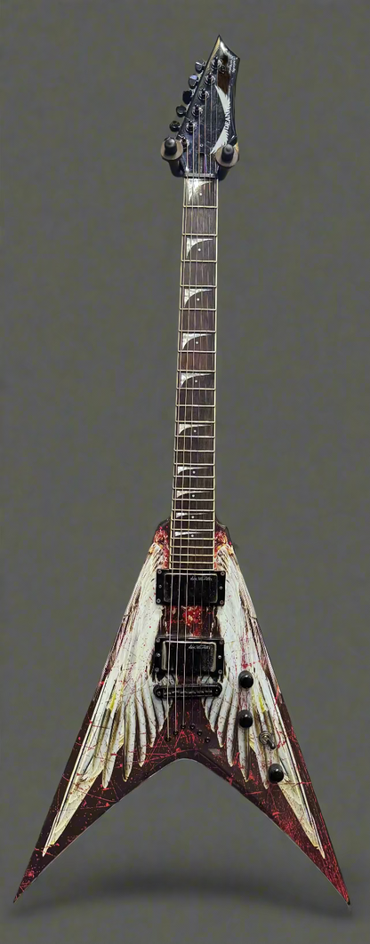 Fancy electric guitar with a unique design in front of a wall of other guitars