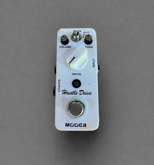 Moog Hustle Drive guitar effects pedal on a wooden surface