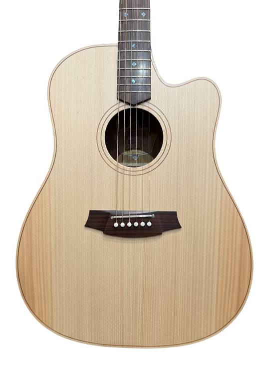 Acoustic guitar with a wooden finish in front of a wall of guitars