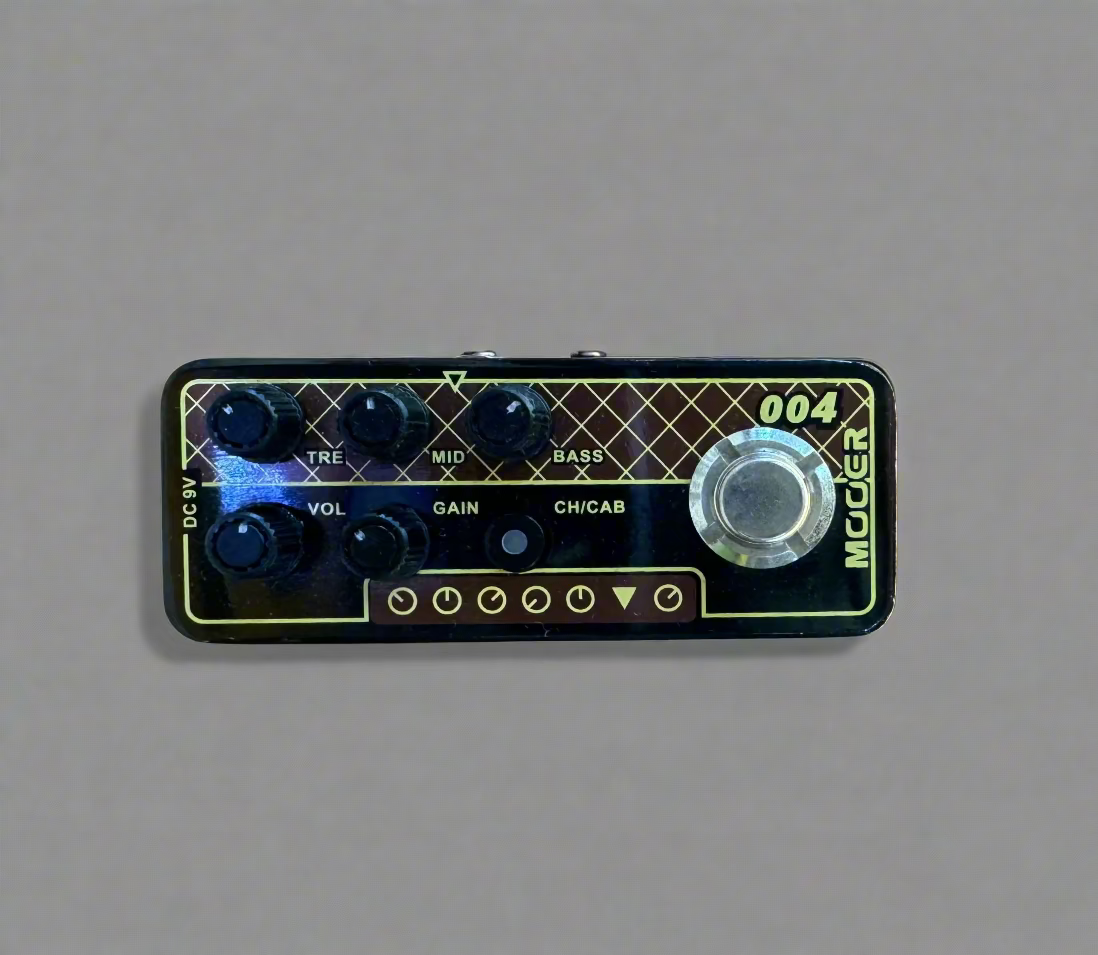 Guitar effects pedal with control knobs on a wooden surface