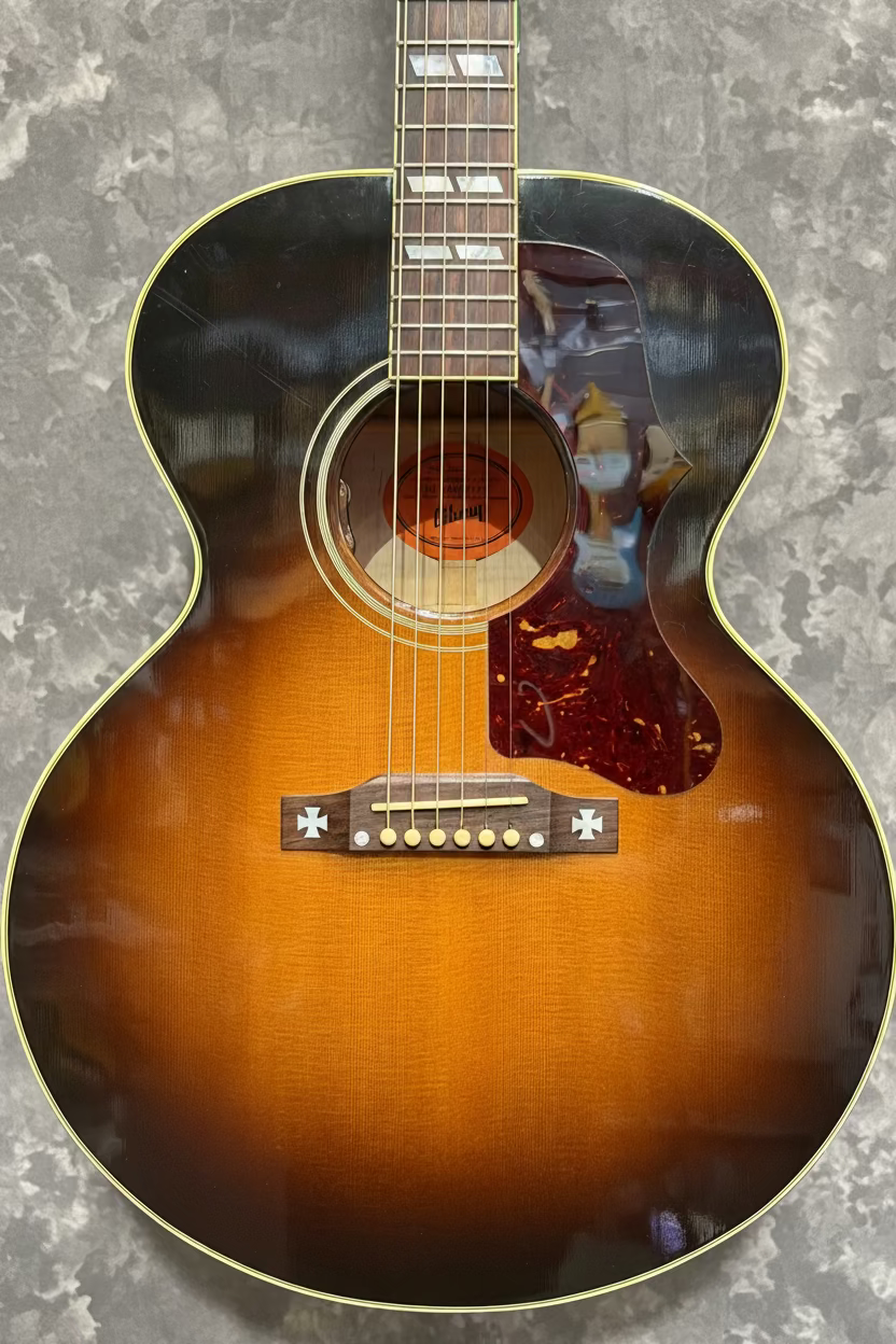 Acoustic guitar with a sunburst finish on a white background