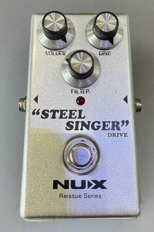 Nux Steel Singer guitar effects pedal on a green background