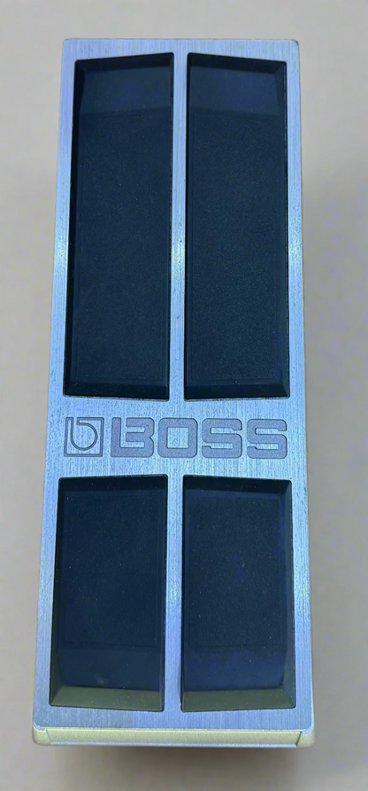 Boss guitar effects pedal on a wooden surface
