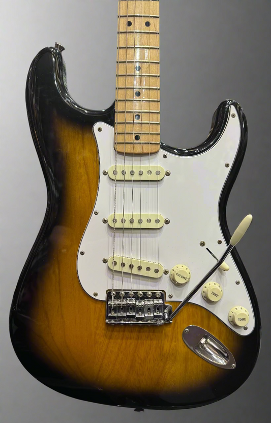 Fender Stratocaster guitar with sunburst finish in a music store setting