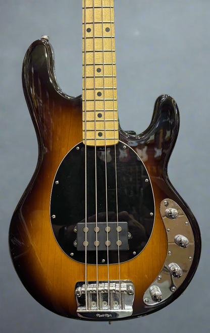 Bass guitar with a sunburst finish in a music store setting