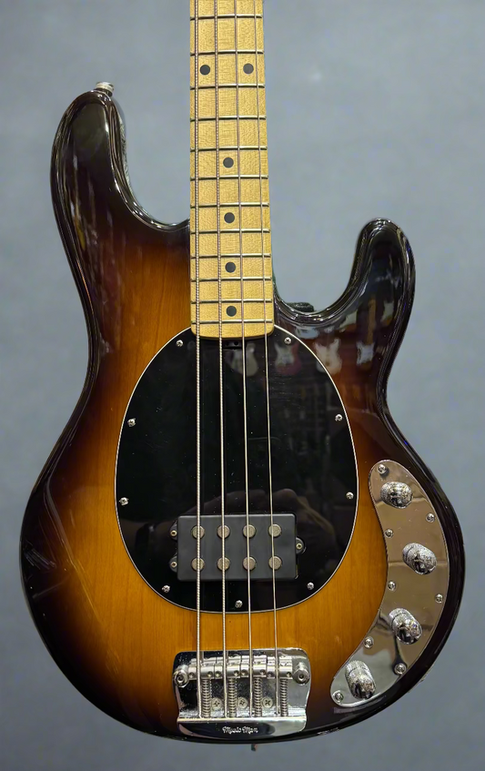 Bass guitar with a sunburst finish in a music store setting