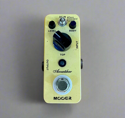 Guitar effects pedal on a wooden surface